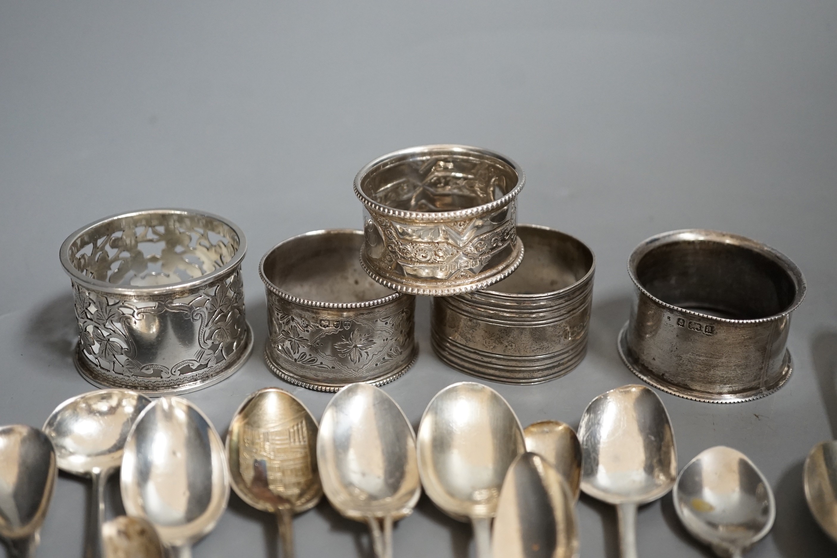 A miscellaneous collection of small silver items to include napkin rings, spoons, etc.